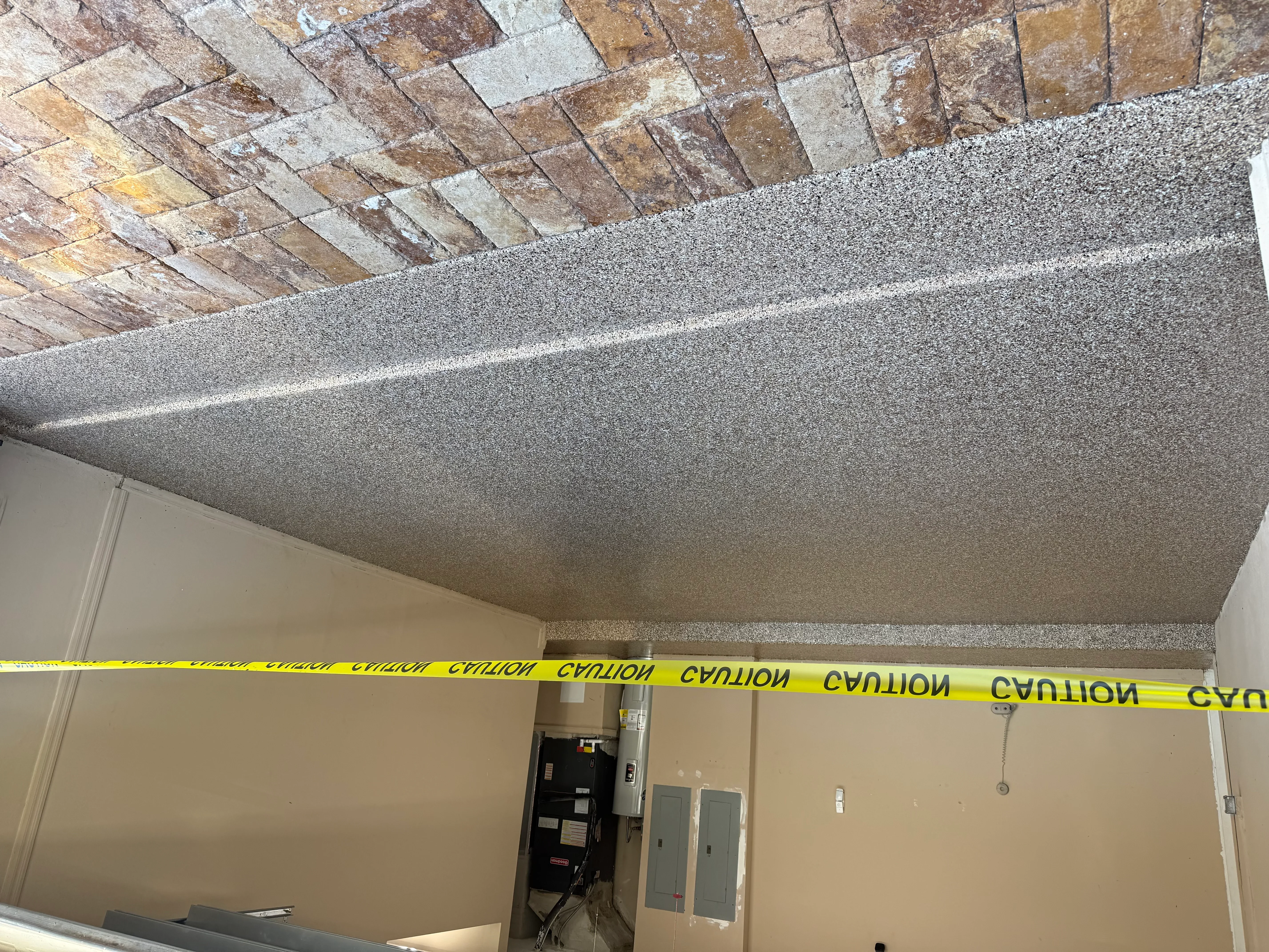 Smooth drywall ceiling installation with removed popcorn texture and brick soffit detail