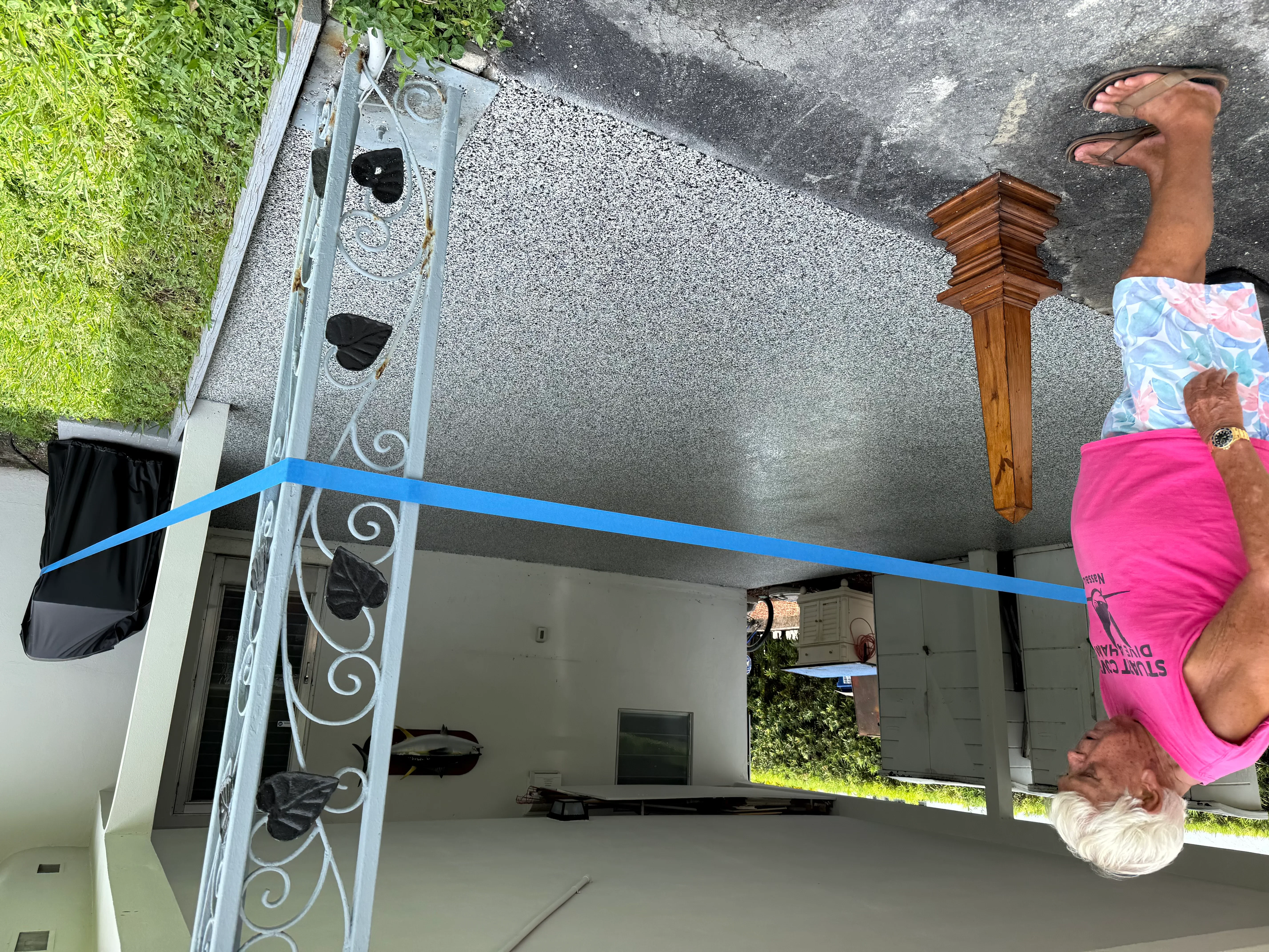 Finished concrete carport slab with metal posts and scrollwork details