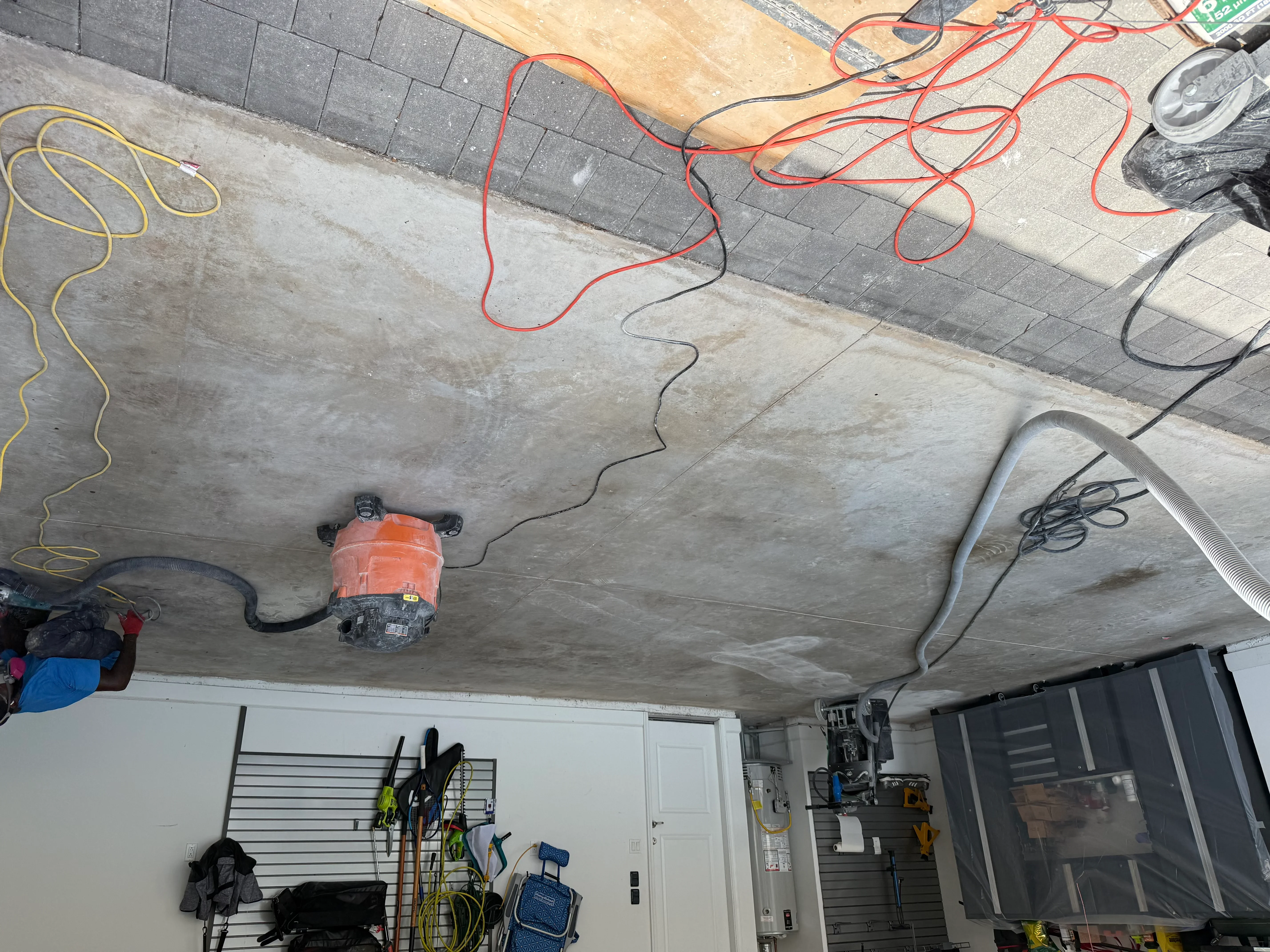 Concrete floor grinding and preparation with equipment and power cords on interior surface